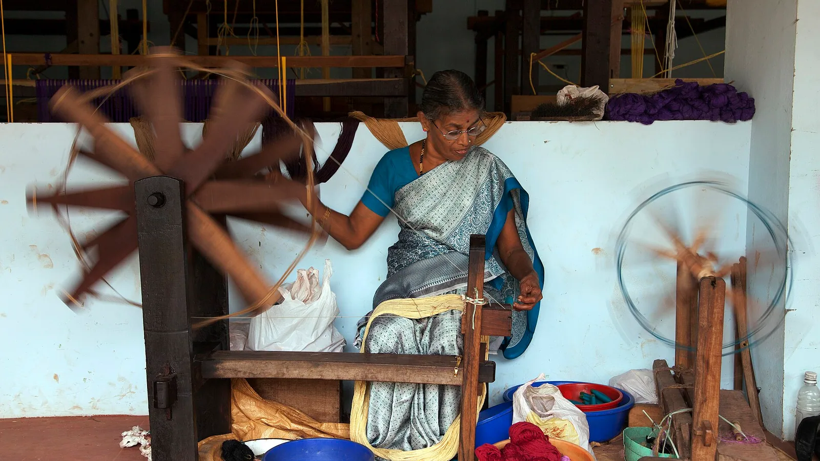 Handloom saree draped on a wooden hanger with natural light